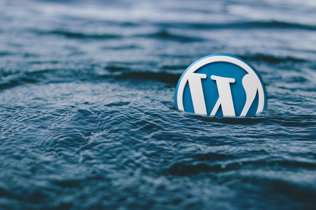 The WordPress "W" logo swimming in a body of water.